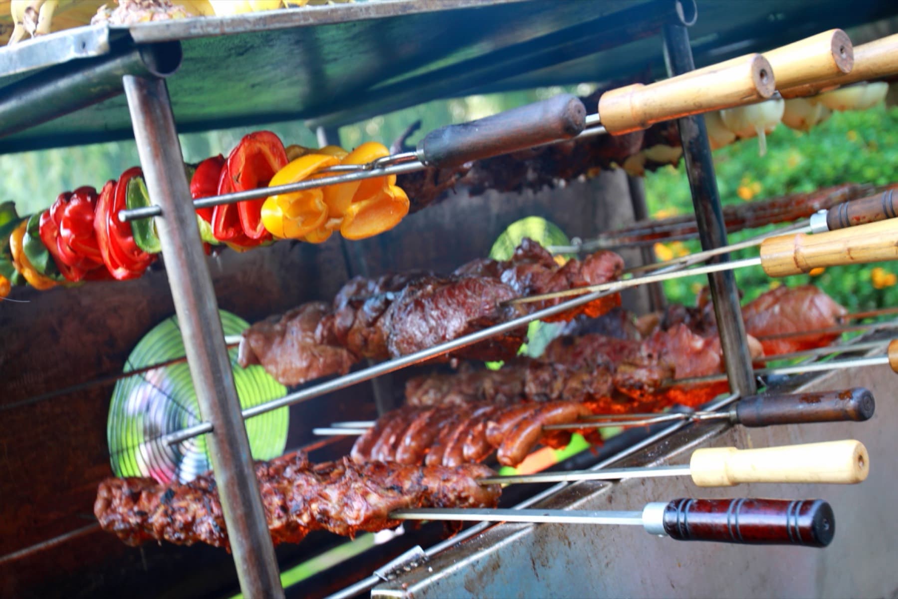 Rodizio-Grill mit Paprika, Fleischspießen und Würstchen